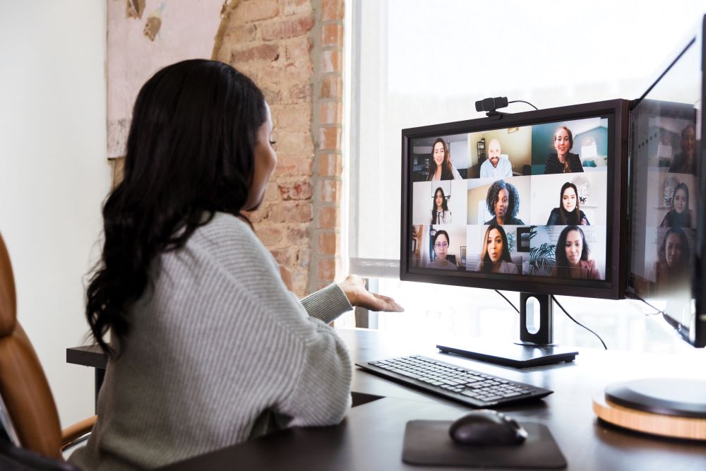 Woman conducting a virtual focus group on her desktop computer.