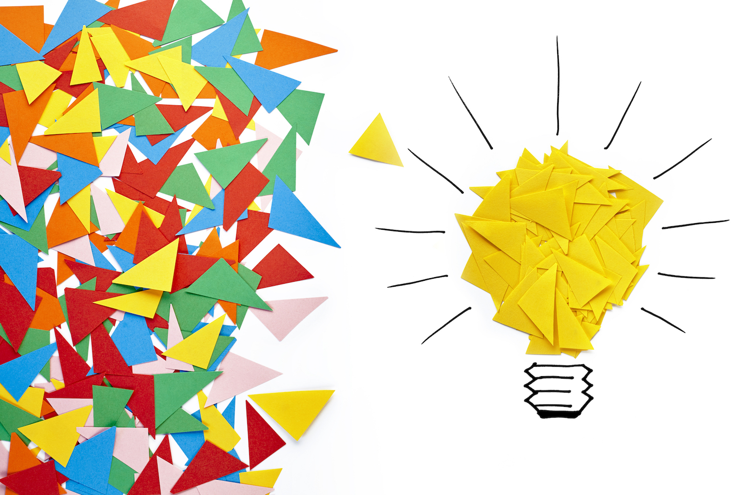 Scraps of colorful paper in a pile on the left and yellow scraps of paper in the form of a light bulb on the right to show how using social media listening can generate ideas.