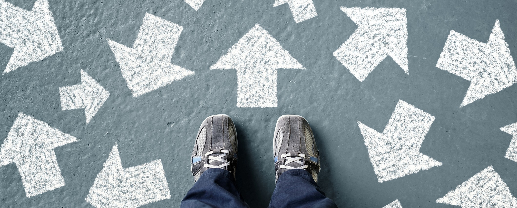 Taking decisions for the future man standing with many direction arrow choices, left, right or move forward