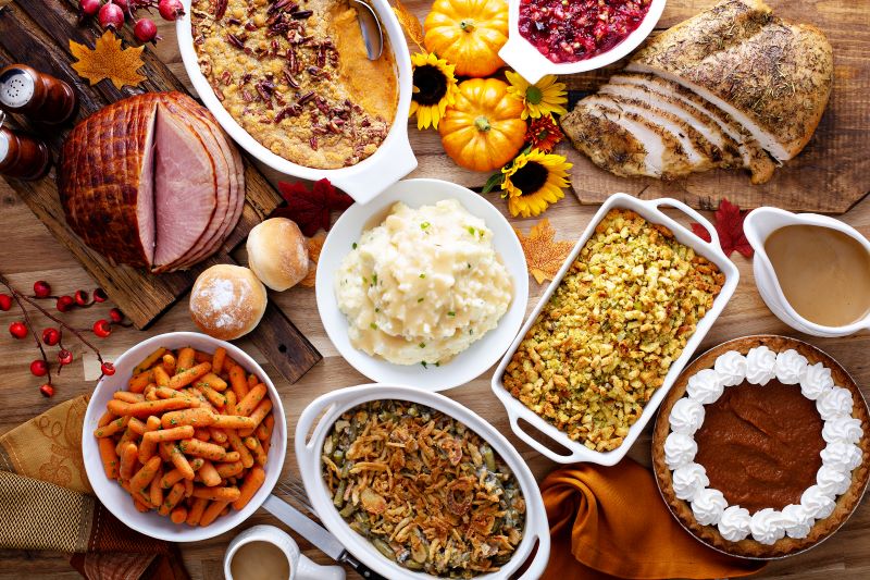 Thanksgiving table with turkey and assortment of side dishes
