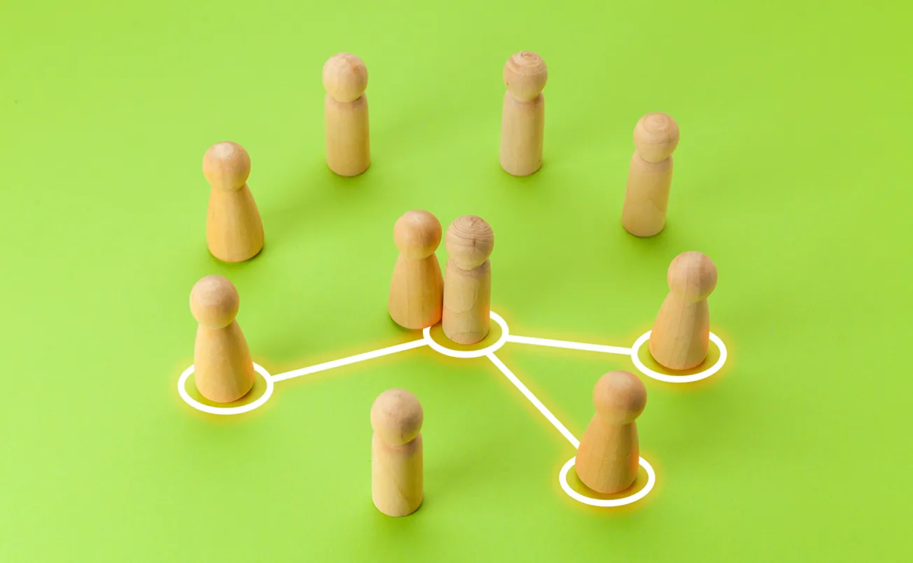 Wooden figures with lines between them on green background