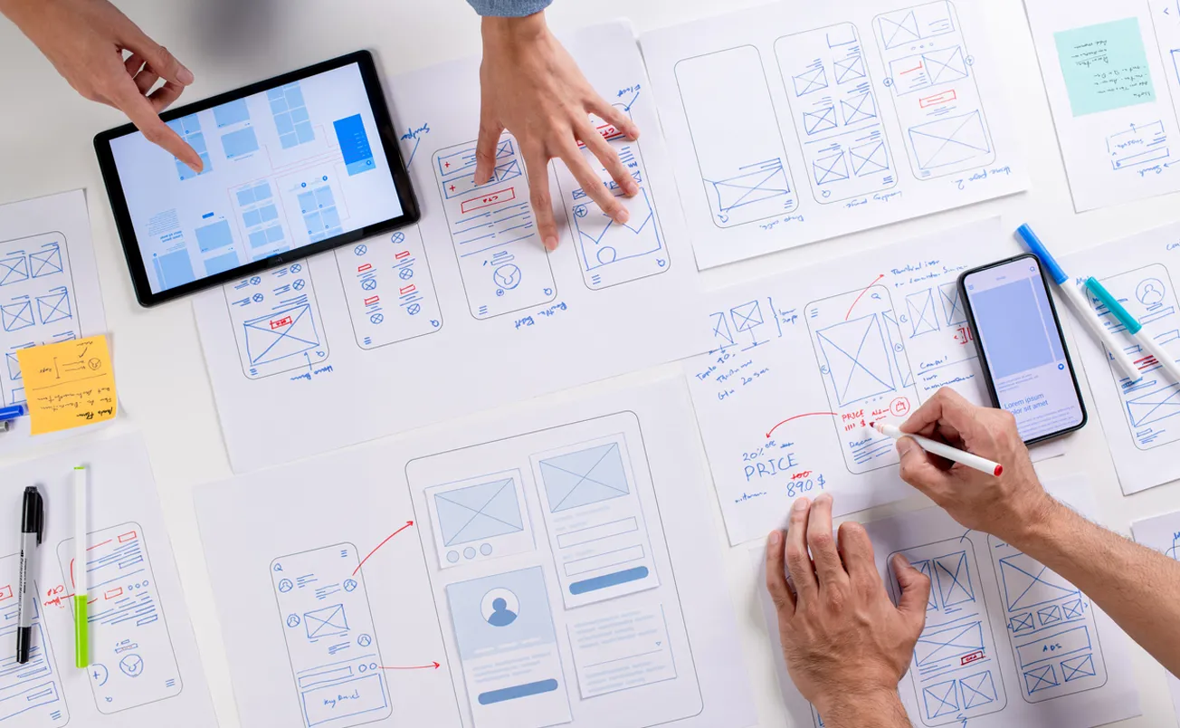 UX/UI designers discussing and brainstorming on wireframes for a website
