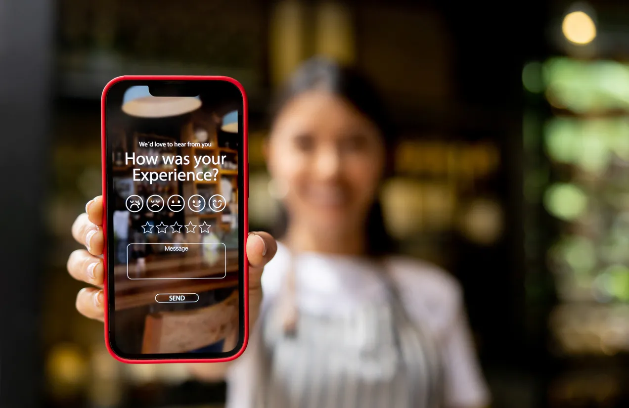 Waitress displaying an app to rate your experience at a restaurant 