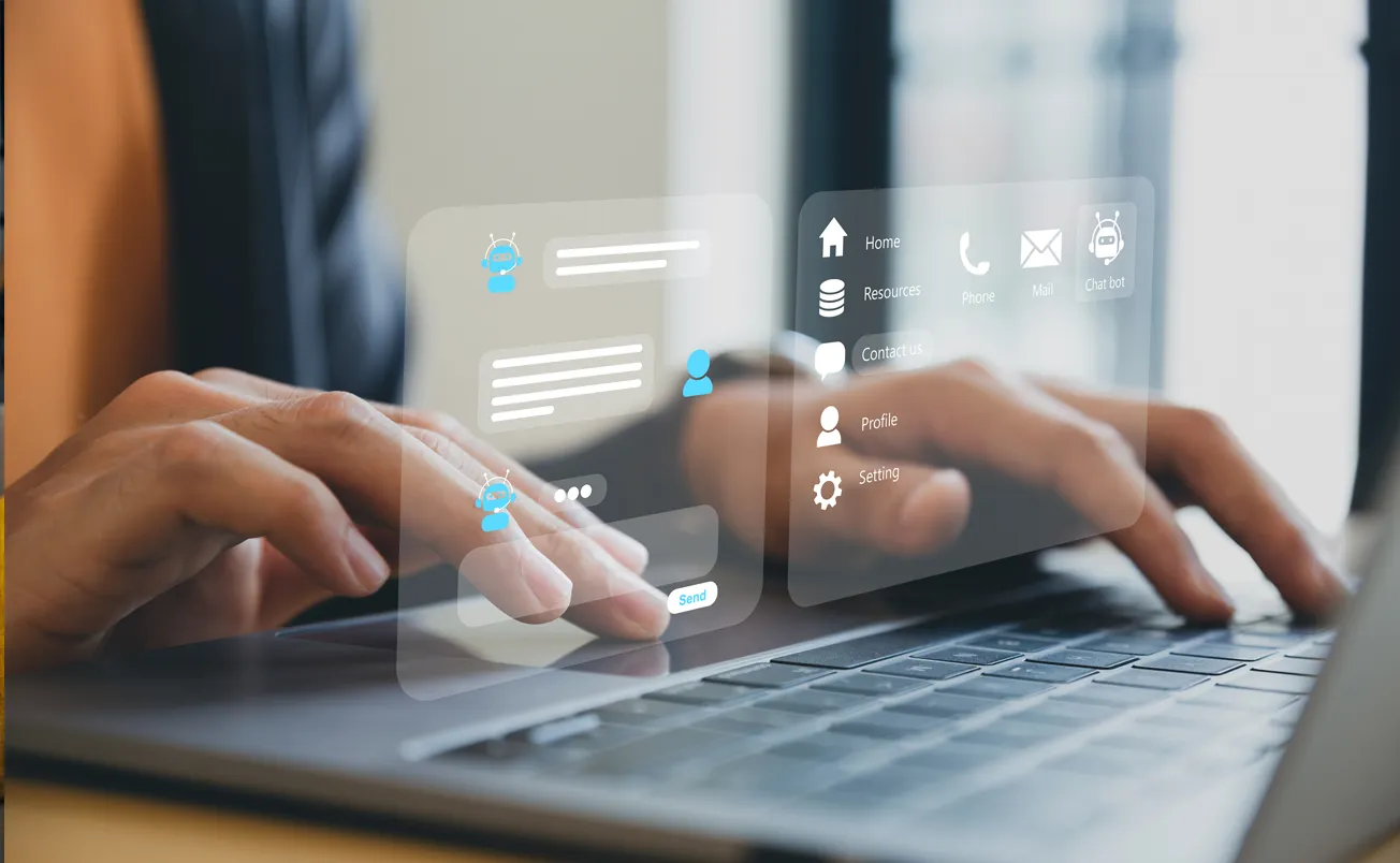 Businessman using laptop computer chatting with chat bot