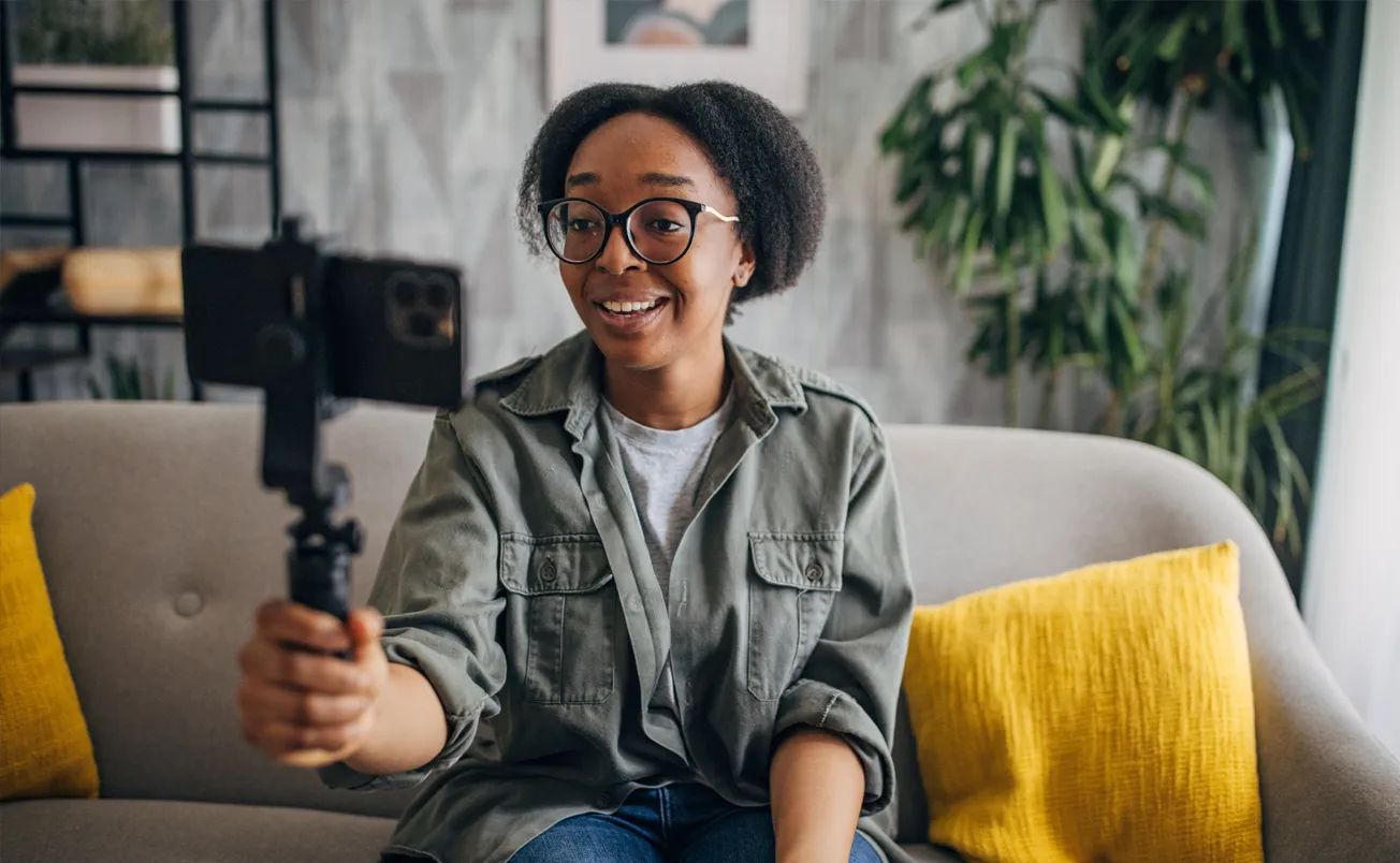 Young woman holding gimbal, engaged in video call