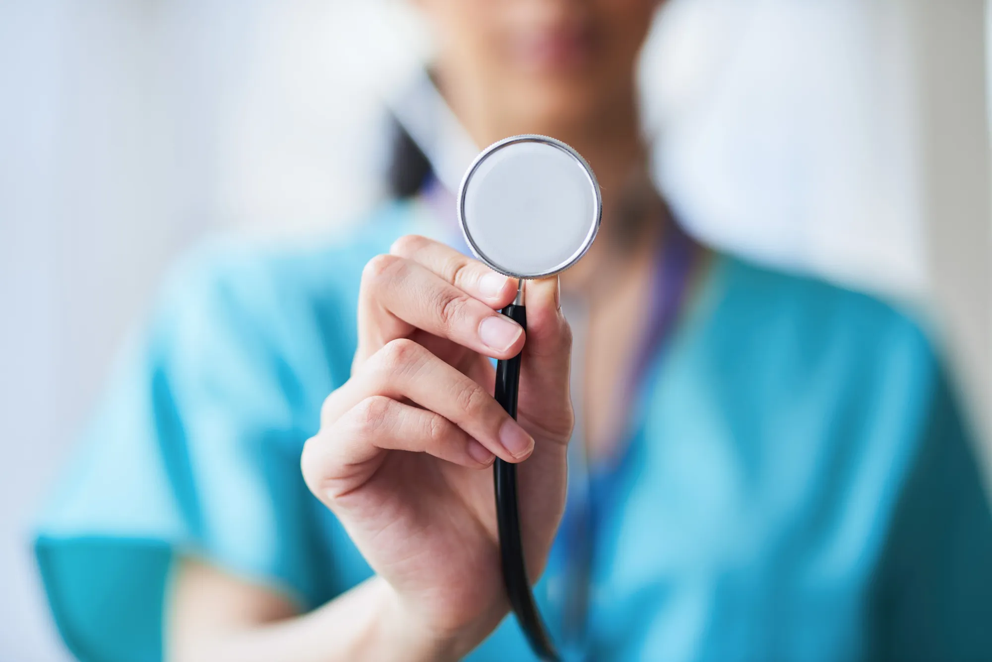 Close-Up of Medical Professional Holding a Stethoscope in Hospital