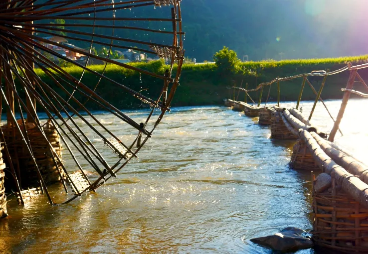 A waterwheel turning in a flowing river, representing the continuous stream of consumer data powering modern brand insights.