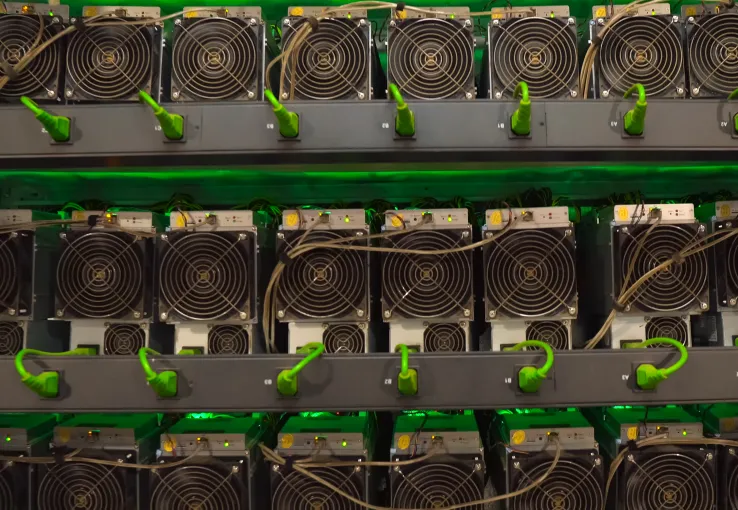 Interior of a digital mining farm filled with video cards and ASIC machines, reflecting the energy-intensive consumer behavior of certain industry sectors and the need for electric utilities and data analytics to optimize operations for a sustainable and net zero future.
