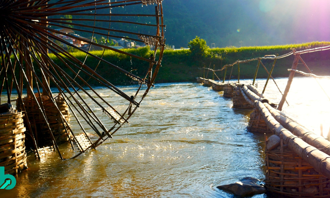 A waterwheel turning in a flowing river, representing the continuous stream of consumer data powering modern brand insights.