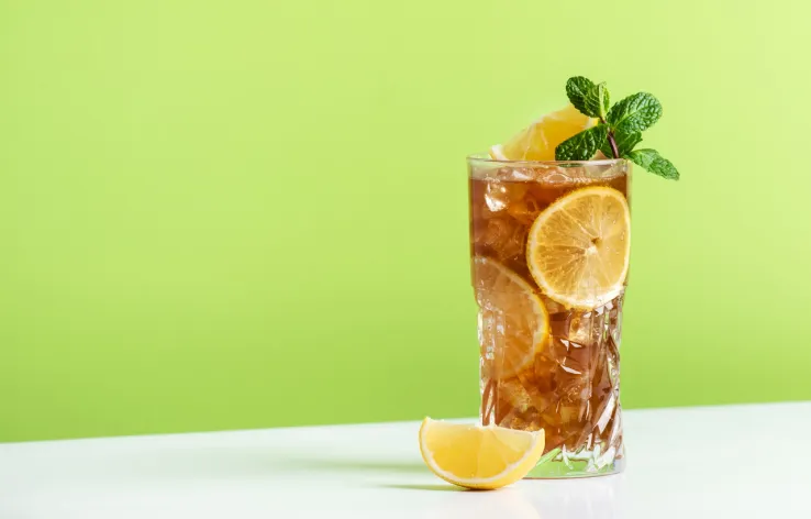 Glass of iced tea with lemon and mint, representing refreshed branding and improved customer insights.